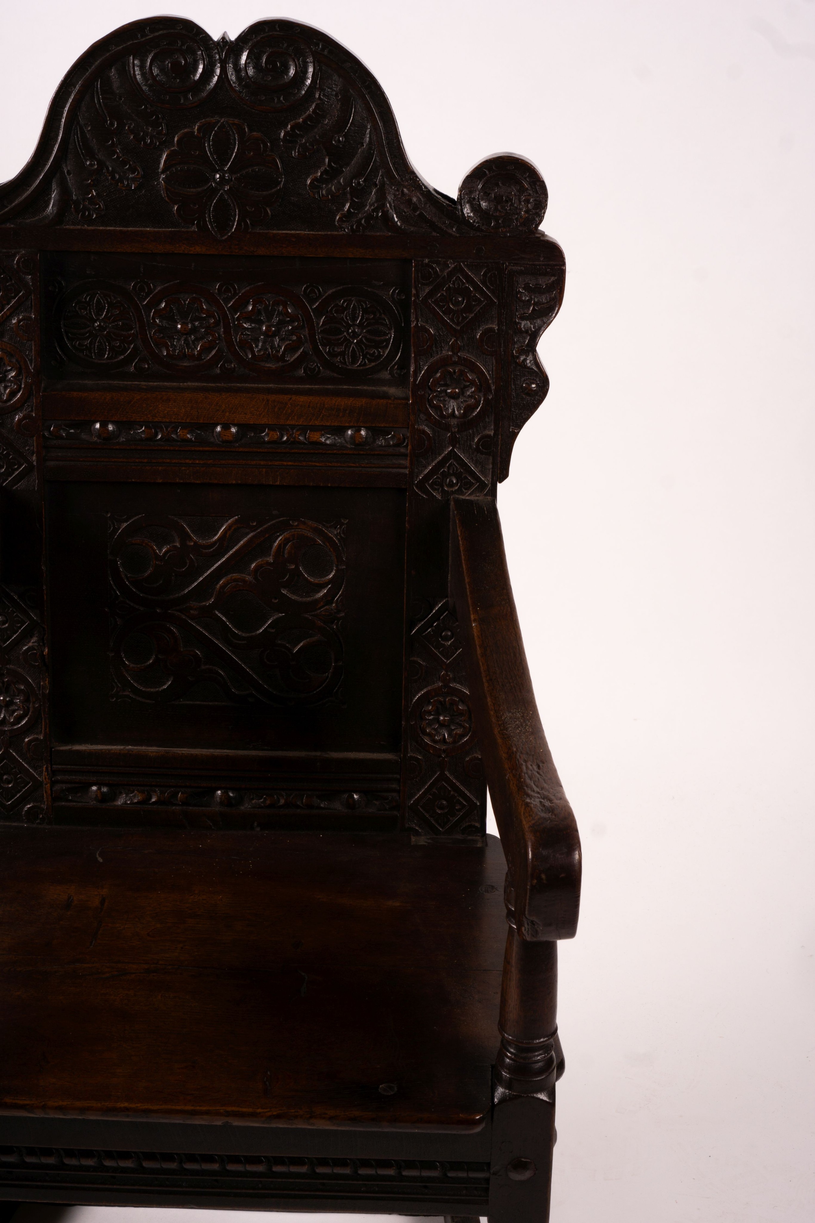 A 17th century Yorkshire area carved oak wainscot chair, width 62cm, depth 48cm, height 118cm